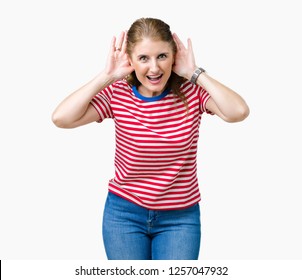 Middle age mature woman wearing casual t-shirt over isolated background Trying to hear both hands on ear gesture, curious for gossip. Hearing problem, deaf