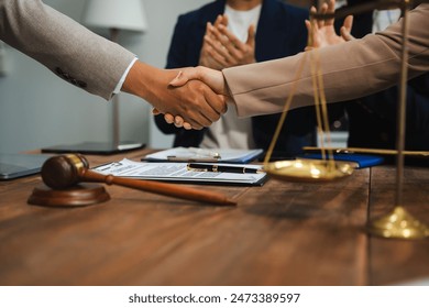 Middle age partner lawyers attorneys shaking hands after discussing a contract agreement done. - Powered by Shutterstock