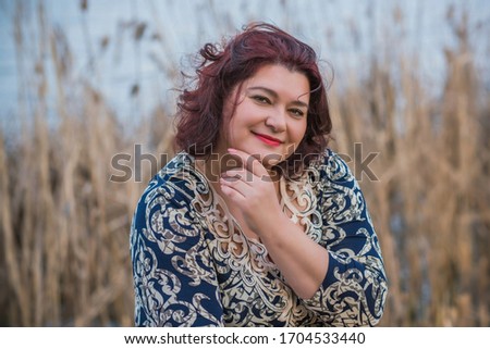 Happy curvy girl with curly hair