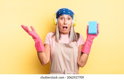 Middle Age Pretty Woman Feeling Extremely Shocked And Surprised. Scourer Cleaner