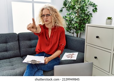 Middle Age Psychologist Woman At Consultation Office Pointing With Finger Up And Angry Expression, Showing No Gesture 