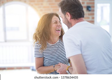 Middle Age Senior Couple Moving To A New House, Smiling Happy In Love With Apartmant