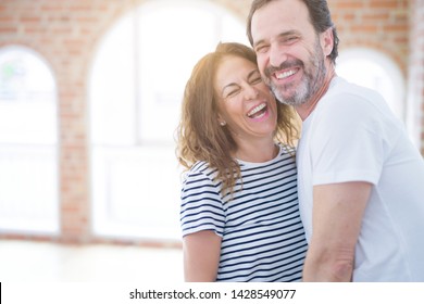 Middle Age Senior Couple Moving To A New House, Smiling Happy In Love With Apartmant