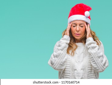 Middle Age Senior Hispanic Woman Wearing Christmas Hat Over Isolated Background With Hand On Head For Pain In Head Because Stress. Suffering Migraine.