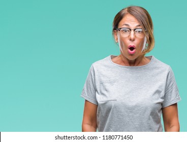 Middle Age Senior Hispanic Woman Wearing Glasses Over Isolated Background Afraid And Shocked With Surprise Expression, Fear And Excited Face.