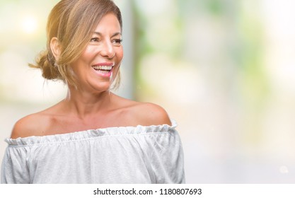 Middle Age Senior Hispanic Woman Over Isolated Background Looking Away To Side With Smile On Face, Natural Expression. Laughing Confident.