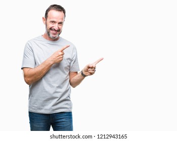 Middle age senior hoary man over isolated background smiling and looking at the camera pointing with two hands and fingers to the side. - Shutterstock ID 1212943165