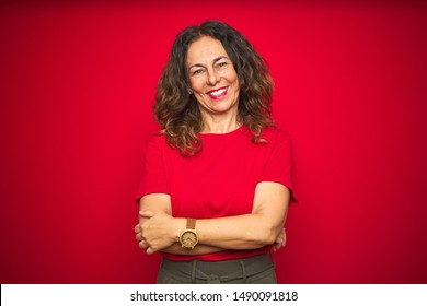 Middle Age Senior Woman With Curly Hair Over Red Isolated Background Happy Face Smiling With Crossed Arms Looking At The Camera. Positive Person.