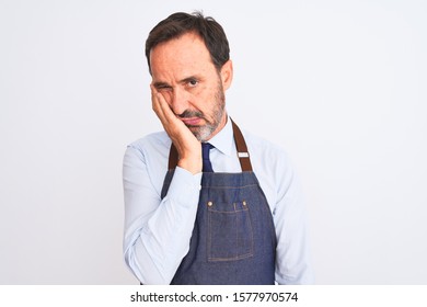 Middle Age Shopkeeper Man Wearing Apron Standing Over Isolated White Background Thinking Looking Tired And Bored With Depression Problems With Crossed Arms.