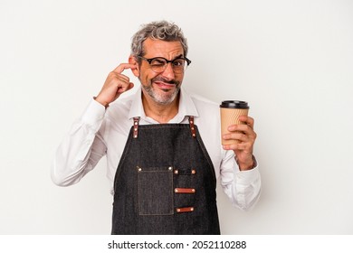 Middle Age Store Clerk Holding A Take Away Coffee Isolated On White Background  Covering Ears With Hands.