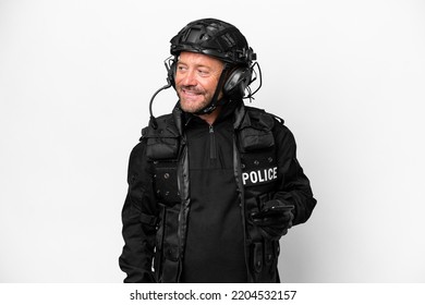 Middle Age SWAT Man Isolated On White Background Keeping A Conversation With The Mobile Phone With Someone