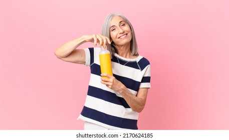 Middle Age White Hair Woman Holding A Coffee Thermos