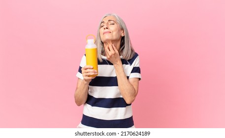 Middle Age White Hair Woman Holding A Coffee Thermos