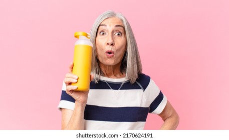 Middle Age White Hair Woman Holding A Coffee Thermos