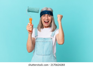 Middle Age White Hair Woman Painting A Wall