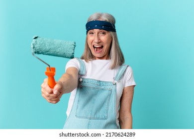 Middle Age White Hair Woman Painting A Wall