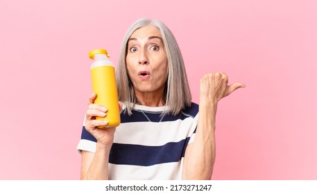 Middle Age White Hair Woman Holding A Coffee Thermos