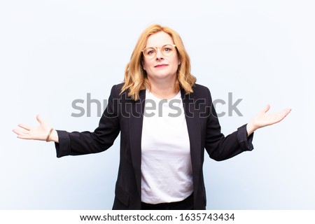middle age woman feeling clueless and confused, having no idea, absolutely puzzled with a dumb or foolish look