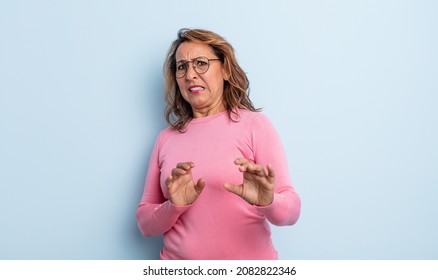 Middle Age Woman Feeling Disgusted And Nauseous, Backing Away From Something Nasty, Smelly Or Stinky, Saying Yuck