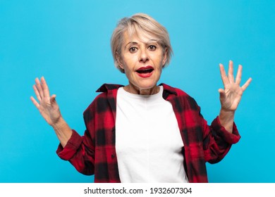 Middle Age Woman Feeling Stupefied And Scared, Fearing Something Frightening, With Hands Open Up Front Saying Stay Away