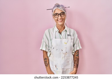 Middle age woman with grey hair wearing artist look looking positive and happy standing and smiling with a confident smile showing teeth  - Shutterstock ID 2253877245