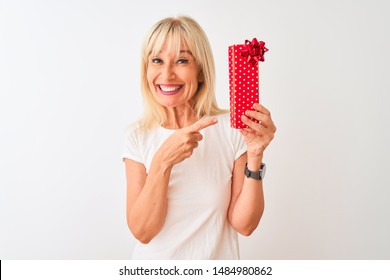 Middle Age Woman Holding Valentine Gift Standing Over Isolated White Background Very Happy Pointing With Hand And Finger