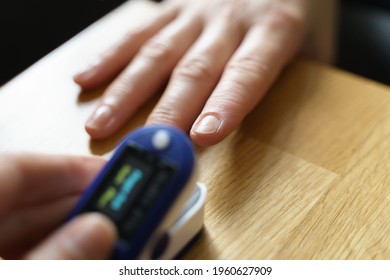 Middle Age Woman At Home Checking Blood Oxygen Level With Pulse Oximeter. Coronavirus Covid Symptoms. Asthma, Lungs Decease.