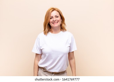 Middle Age Woman Looking Happy And Goofy With A Broad, Fun, Loony Smile And Eyes Wide Open