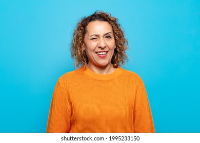 Middle Age Woman Looking Happy And Friendly, Smiling And Winking An Eye At You With A Positive Attitude