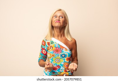 Middle Age Woman Looking Happy And Friendly, Smiling And Winking An Eye At You With A Positive Attitude