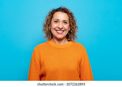 Middle Age Woman Looking Happy And Goofy With A Broad, Fun, Loony Smile And Eyes Wide Open