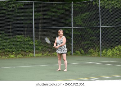 Middle age woman, playing tennis, court, outdoors, activity, summer. - Powered by Shutterstock