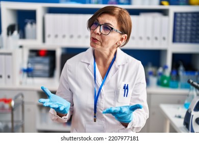 Middle Age Woman Scientist Smiling Confident Speaking At Laboratory