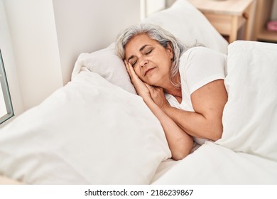 Middle age woman sleeping lying on bed at bedroom - Powered by Shutterstock