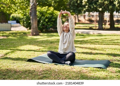 Middle Age Woman Smiling Confident Stretching At Park