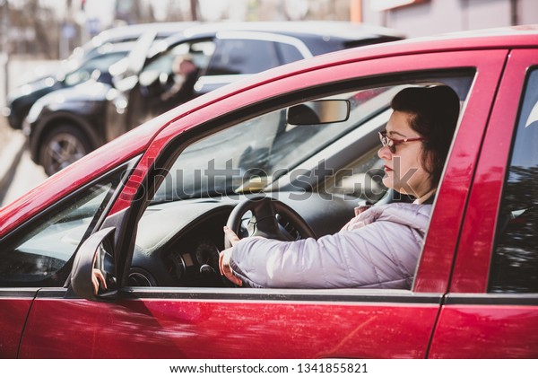 Middle age woman watches\
out of the car is watching , something wrong, problems with trust,\
psychology