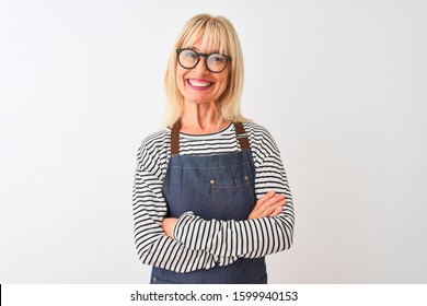 Middle age woman wearing apron and glasses standing over isolated white background happy face smiling with crossed arms looking at the camera. Positive person. - Powered by Shutterstock