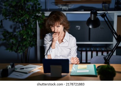 Middle Age Woman Working At The Office At Night Feeling Unwell And Coughing As Symptom For Cold Or Bronchitis. Health Care Concept. 