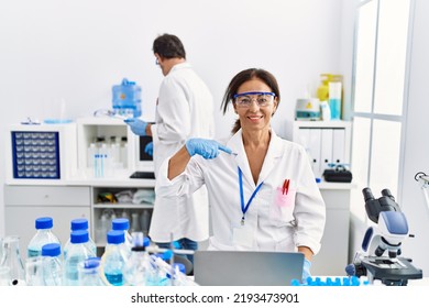 Middle Age Woman Working At Scientist Laboratory Pointing Finger To One Self Smiling Happy And Proud 