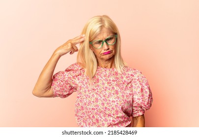 Middle Age Woman Yelling Loudly And Angrily To Copy Space On The Side, With Hand Next To Mouth