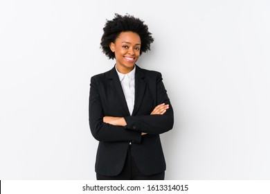 Middle Aged African American Business  Woman Against A White Background Isolated Who Feels Confident, Crossing Arms With Determination.