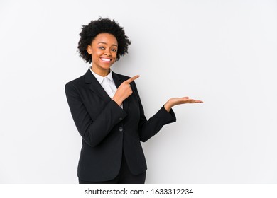 Middle Aged African American Business  Woman Against A White Background Isolated Excited Holding A Copy Space On Palm.