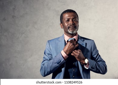 middle aged african american man fixing tie