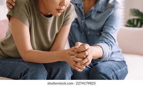 Middle aged asia people old mom holding hands trust comfort help young woman talk crying stress relief at home. Mum as friend love care hold hand adult child feel pain sad worry of life crisis issues. - Shutterstock ID 2274179825