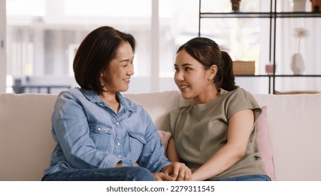 Middle aged asia people old mom love care trust comfort help young teen talk crying stress relief at home. Mum as friend listen adult child woman feel pain sad worry of broken heart life crisis issues - Powered by Shutterstock