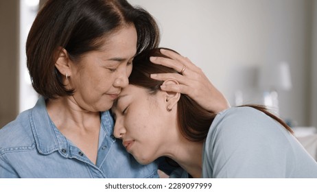 Middle aged asia people old mom love care trust comfort help young teen talk crying stress relief at home. Mum as friend listen adult child woman feel pain sad worry of broken heart life crisis issues - Powered by Shutterstock