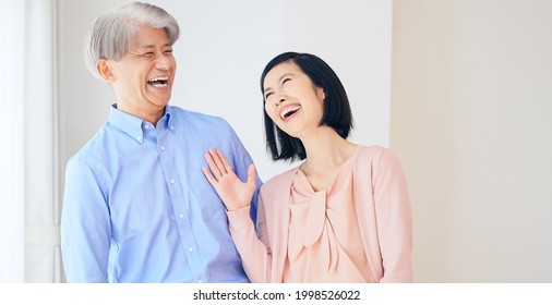 Middle aged asian couple in the house. Senior lifestyle concept.
