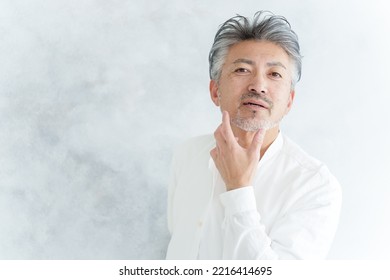 Middle Aged Asian Man Checking Jaw Beard