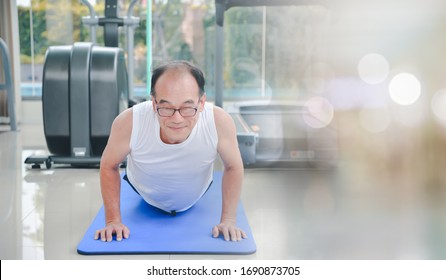 Middle Aged Asian Man Exercise Workout At Sport Gym. Elderly Healthy Man Lifestyle At Gym Club.