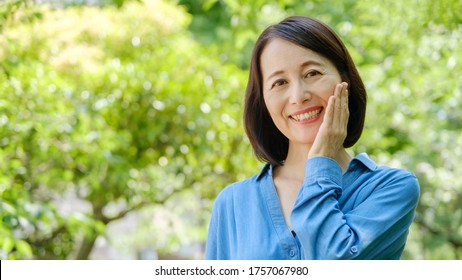 Middle Aged Asian Woman Beauty Image At Park